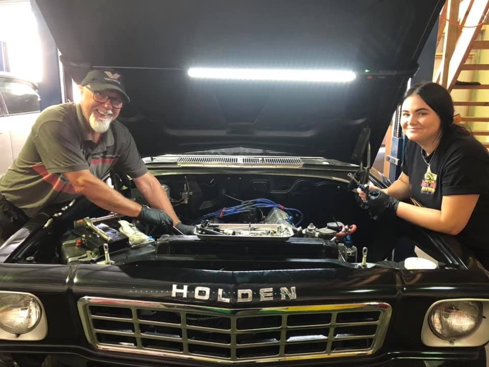 A Man and A Woman Are Working on A Holden Car — Steve Purse Automotive In Huskisson, NSW