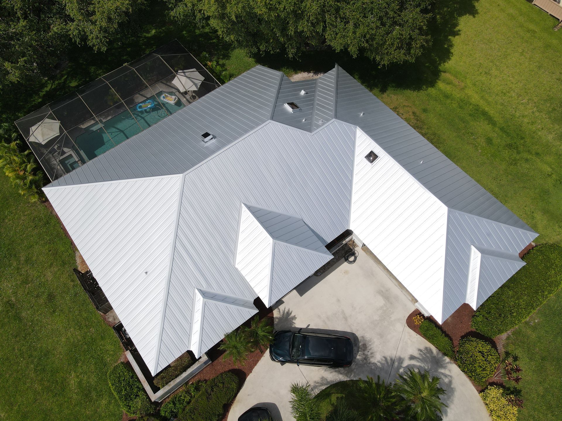 An aerial view of a house with a car parked in front of it.