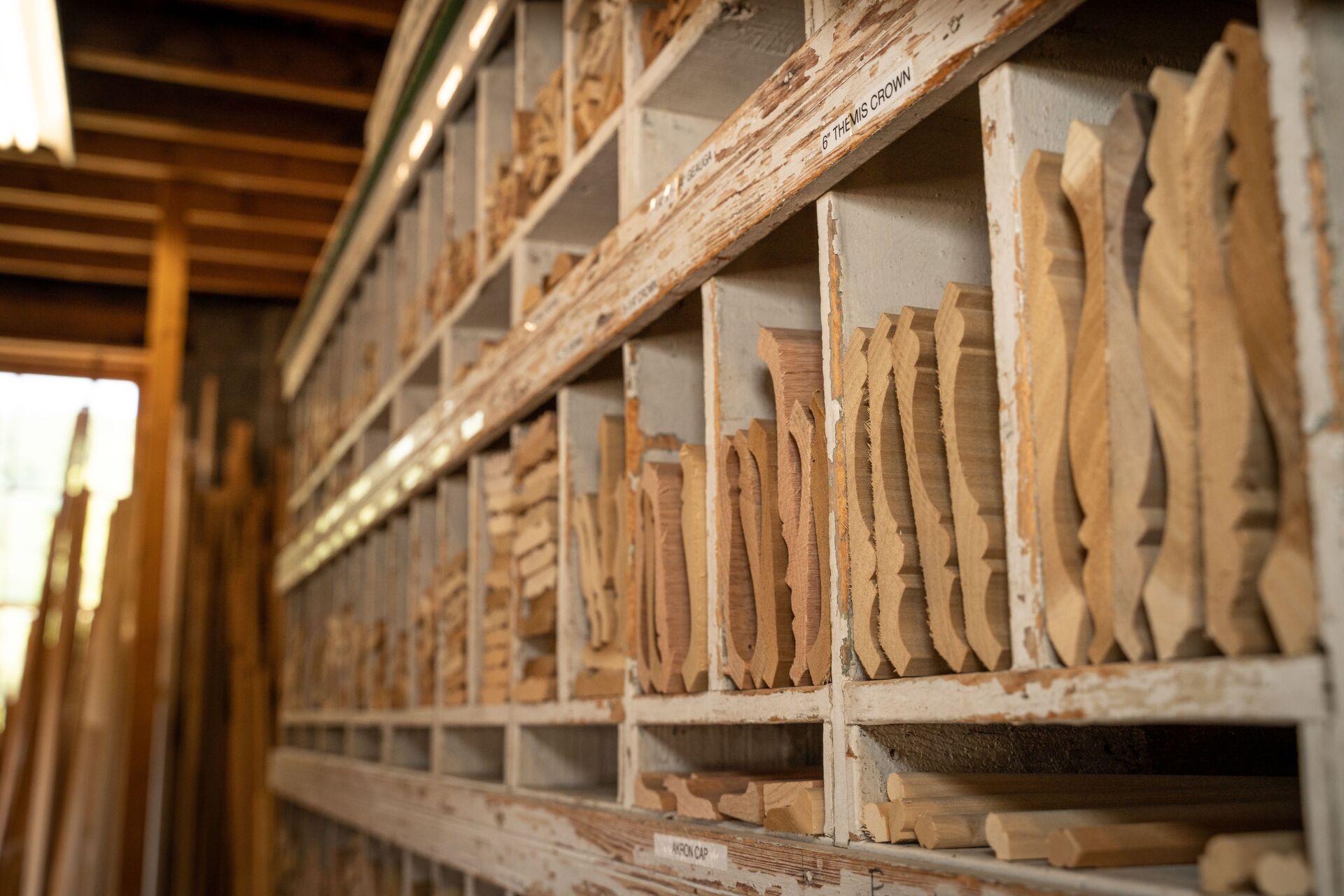 A warehouse filled with shelves filled with wooden pieces.
