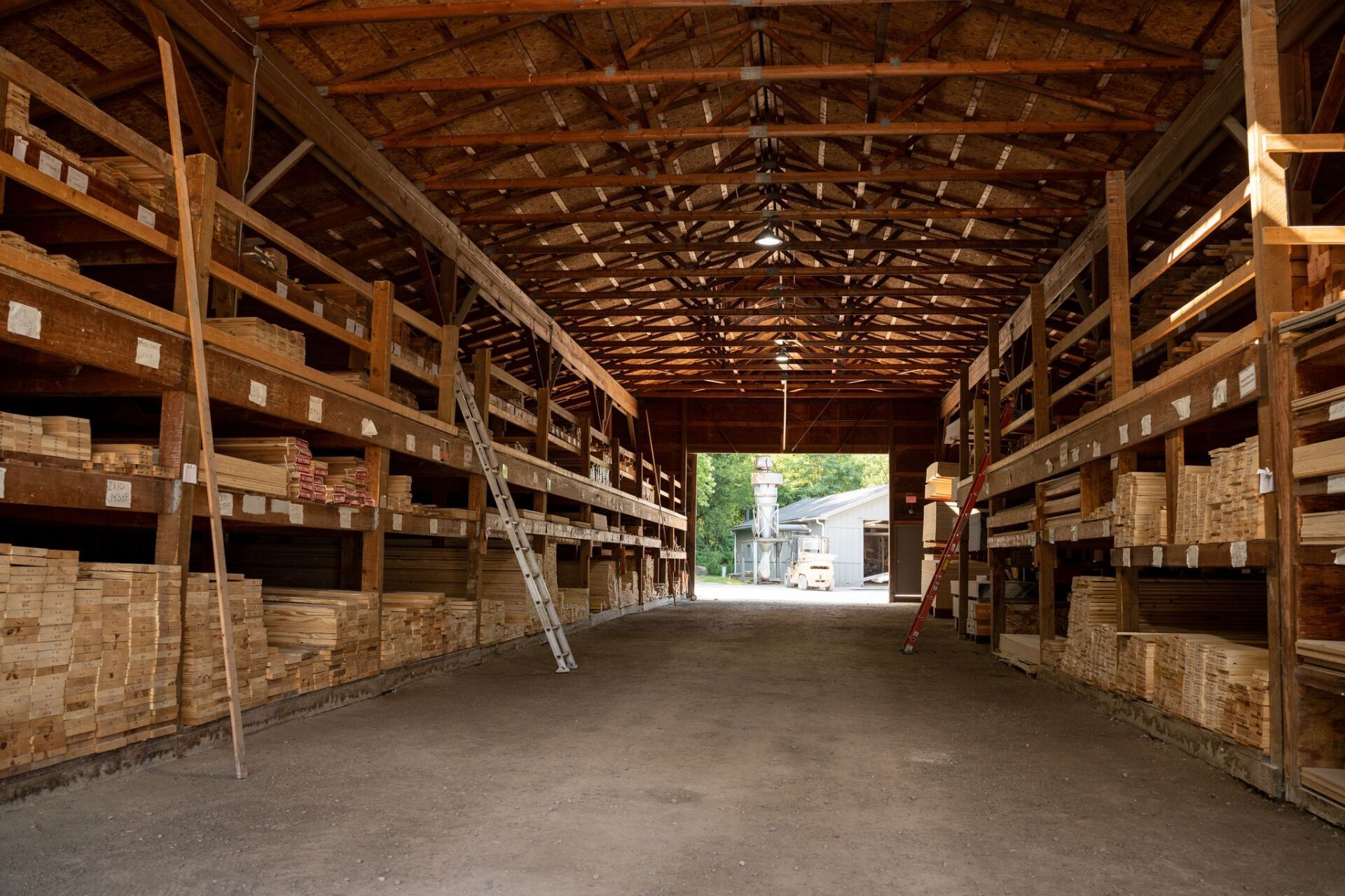 A large warehouse filled with wooden shelves and boxes.