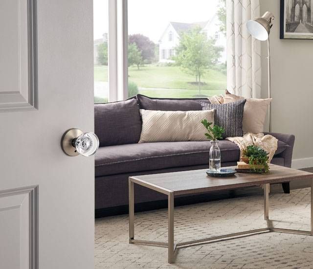 A living room with a purple couch and a coffee table