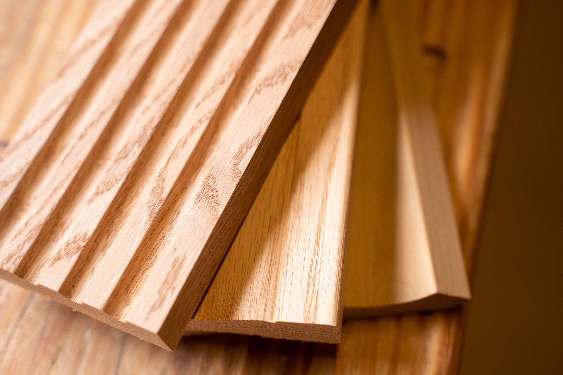 Three pieces of wood are stacked on top of each other on a wooden table.