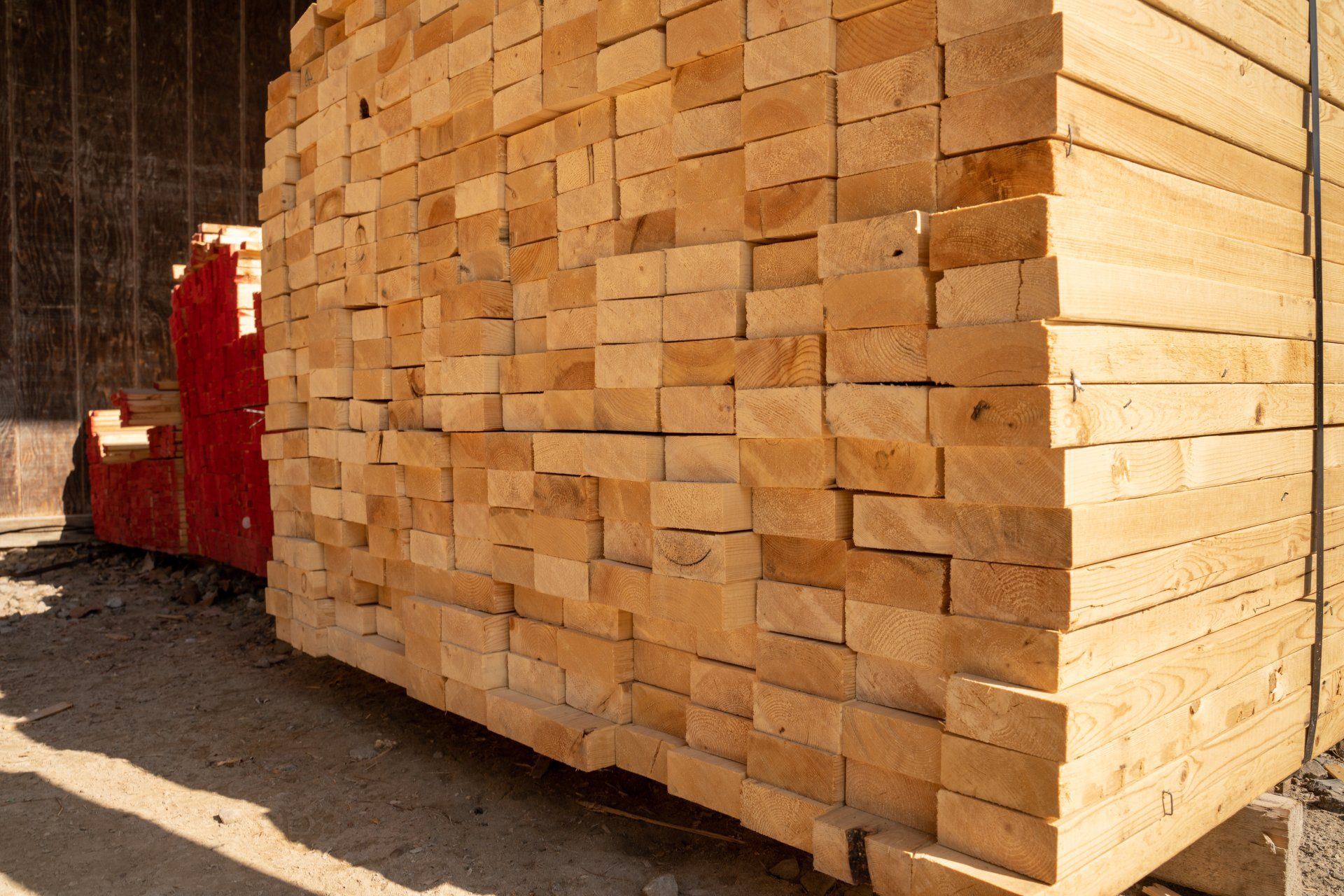 A large pile of wood is stacked on top of each other.