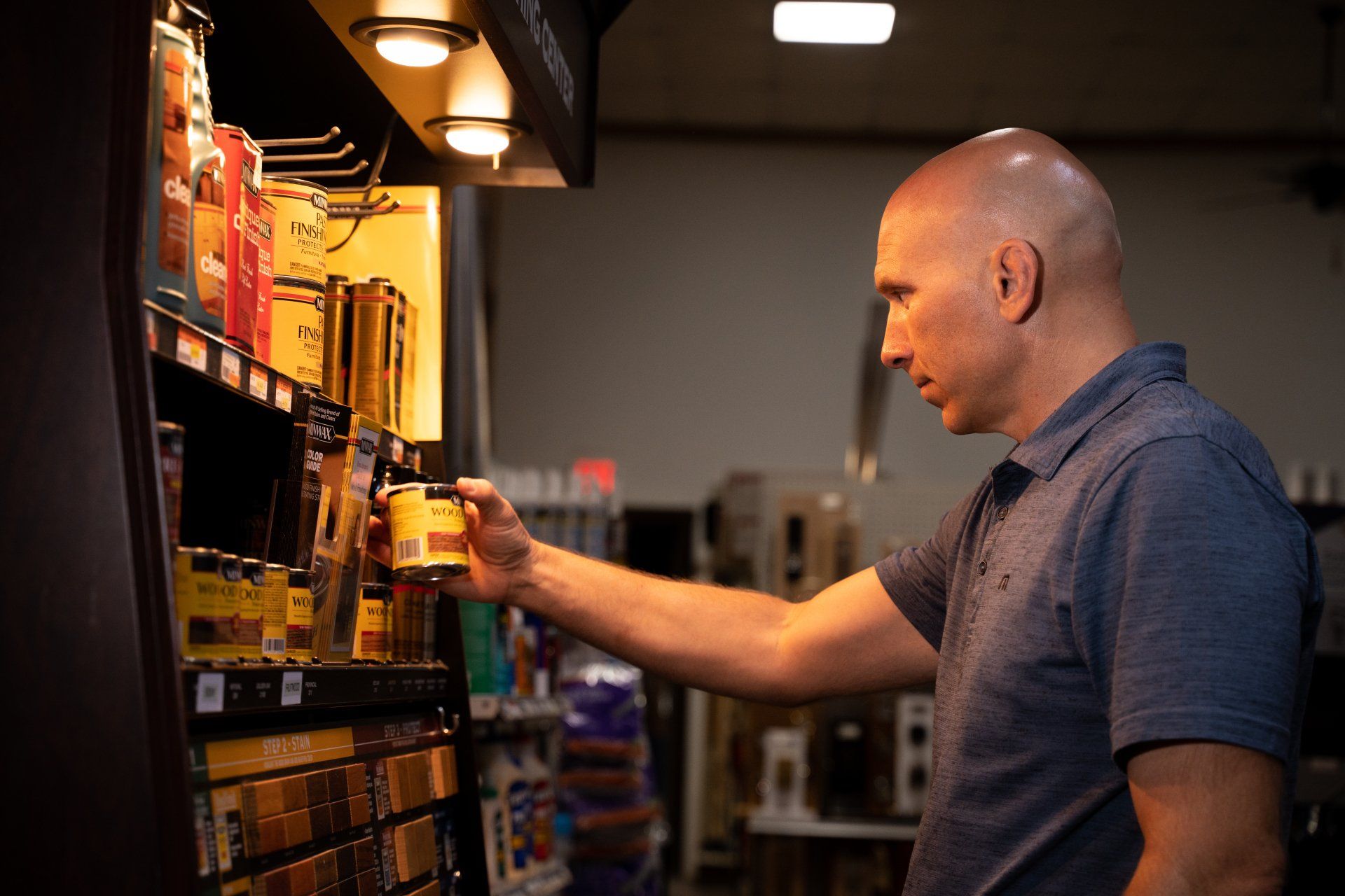 A man is standing in front of a vending machine in a store.