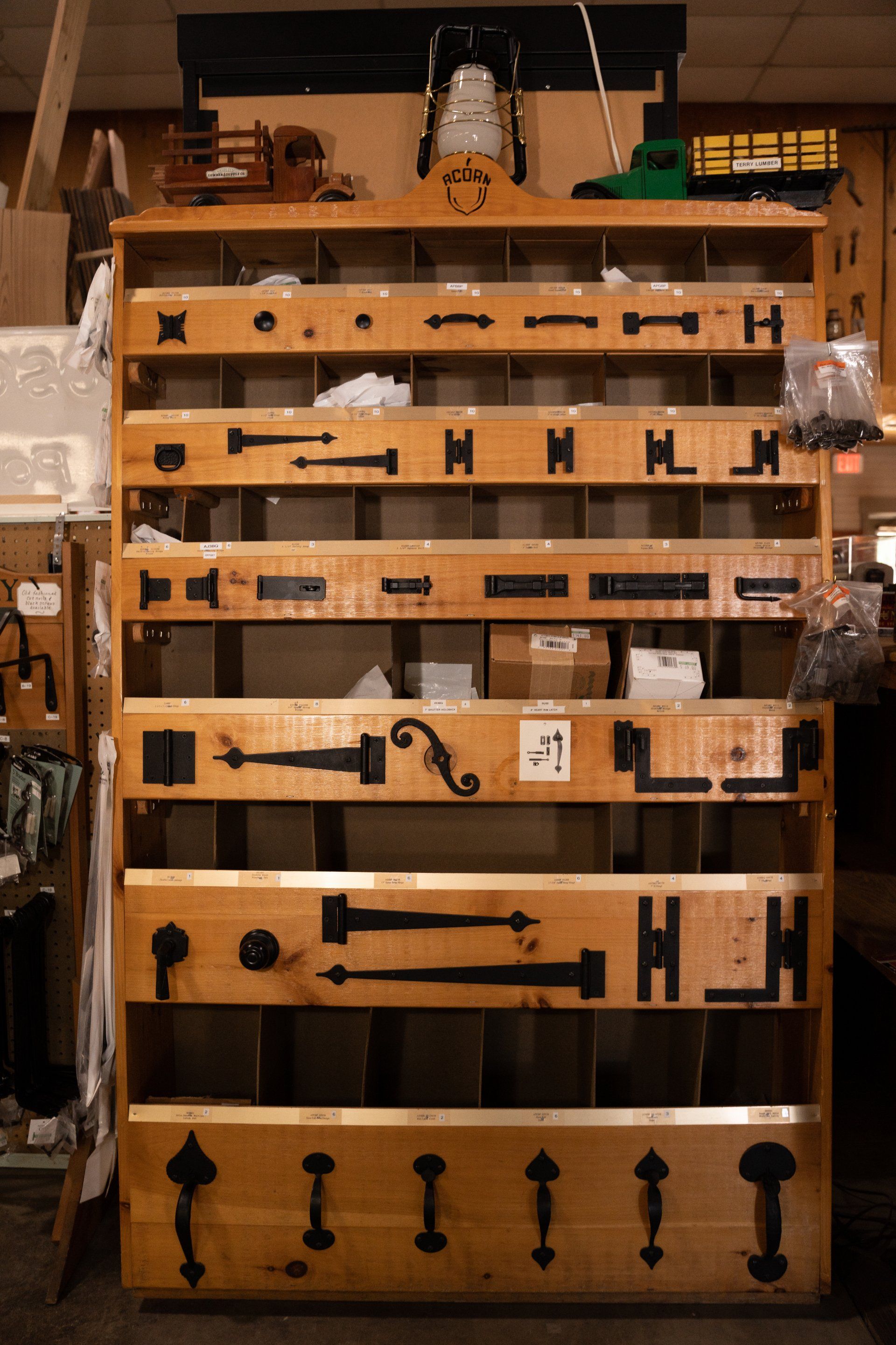A wooden shelf with a lot of different types of hardware on it