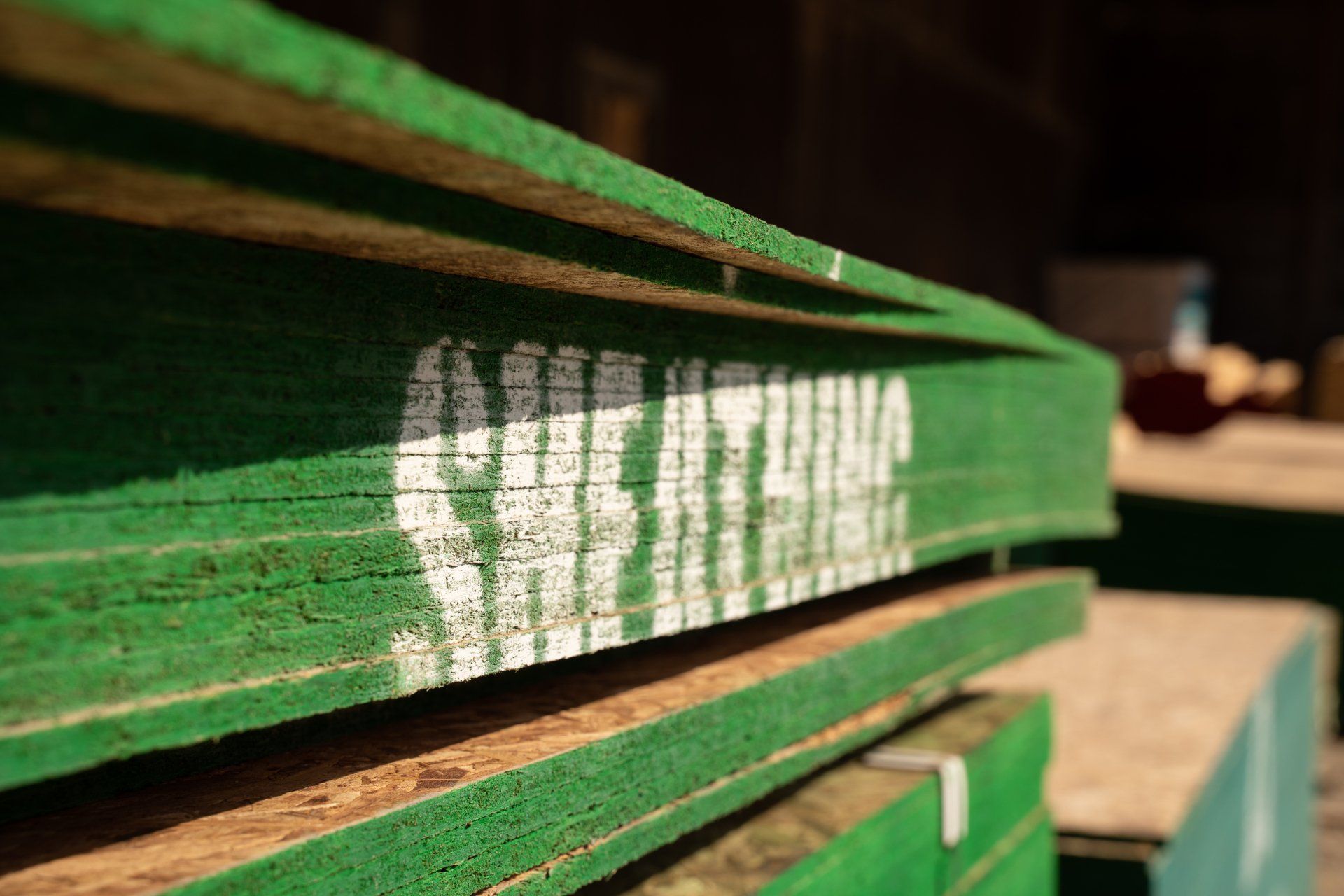 A stack of green wooden boards with the word breathing written on them.