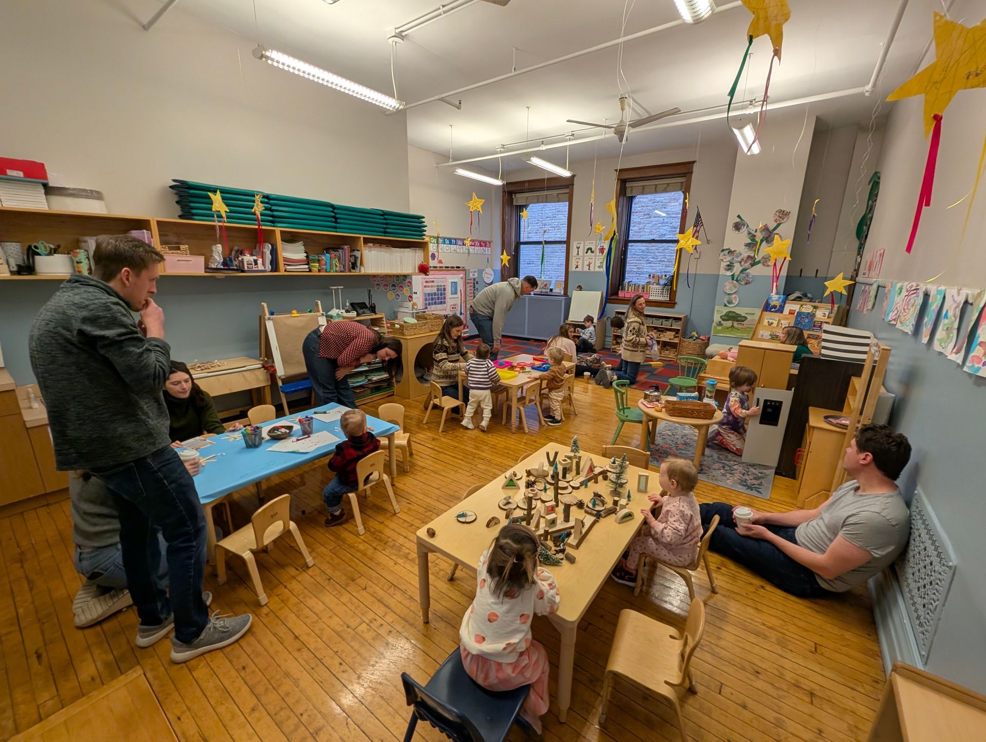 Families exploring our preschool room for Winter Weekends.