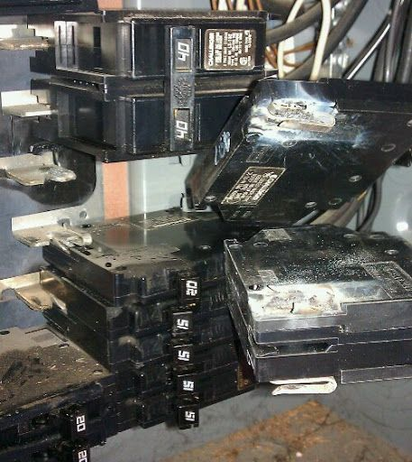 Overheated and burnt Challenger electrical breakers showing visible fire hazard damage