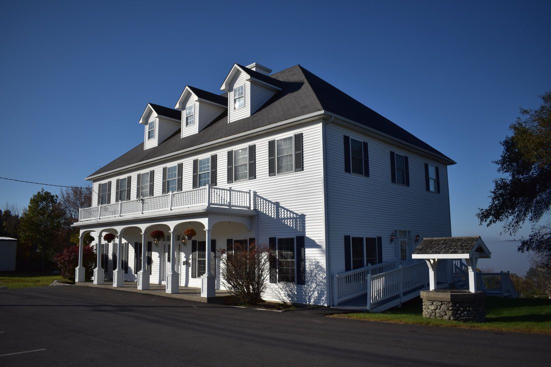 A large white house with a black roof