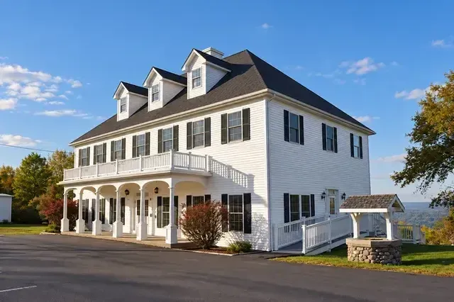 A large white house with a black roof