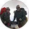 Two people with backpacks posing in a snowy outdoor setting.
