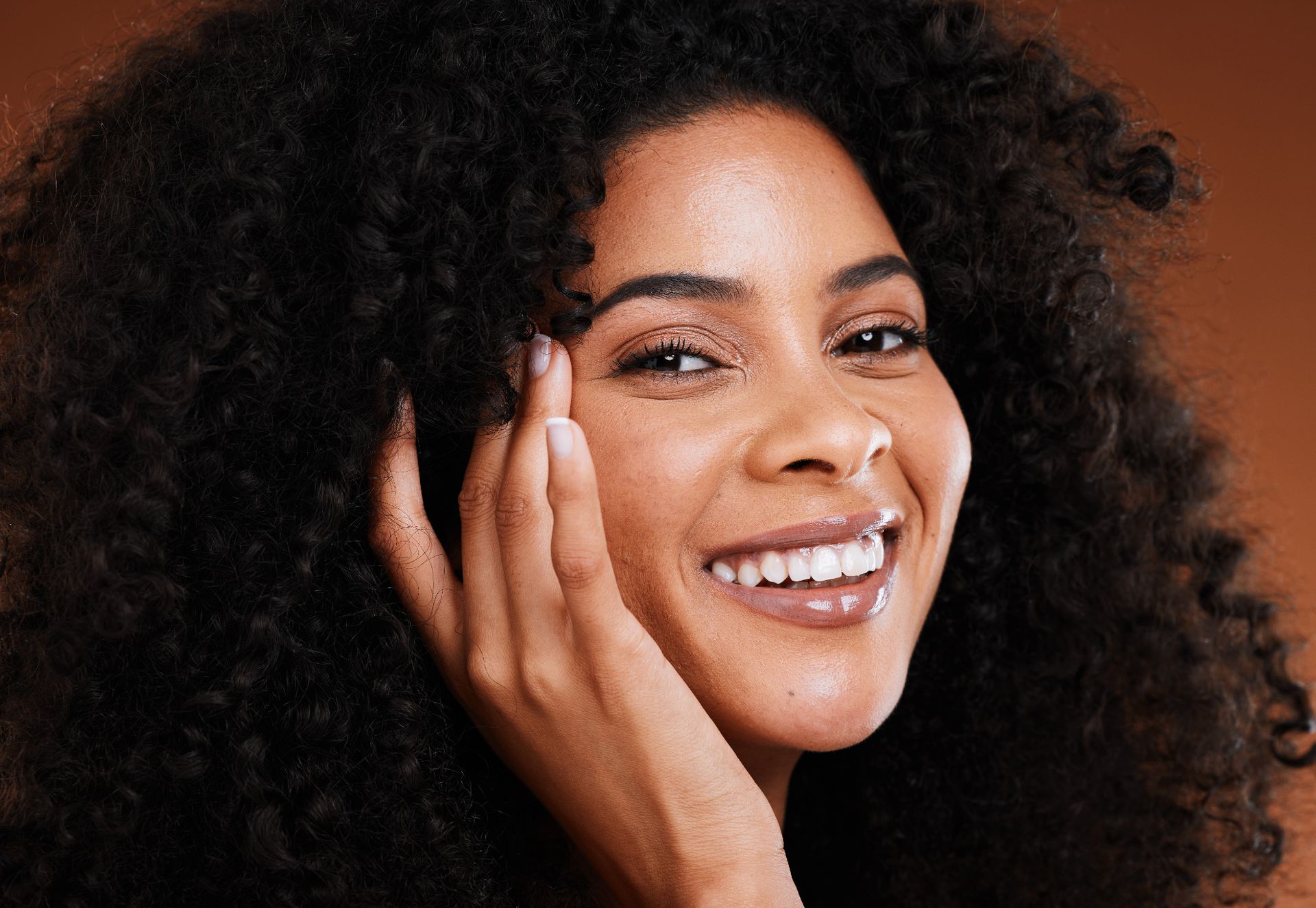 beautiful black woman touching glowing cheek