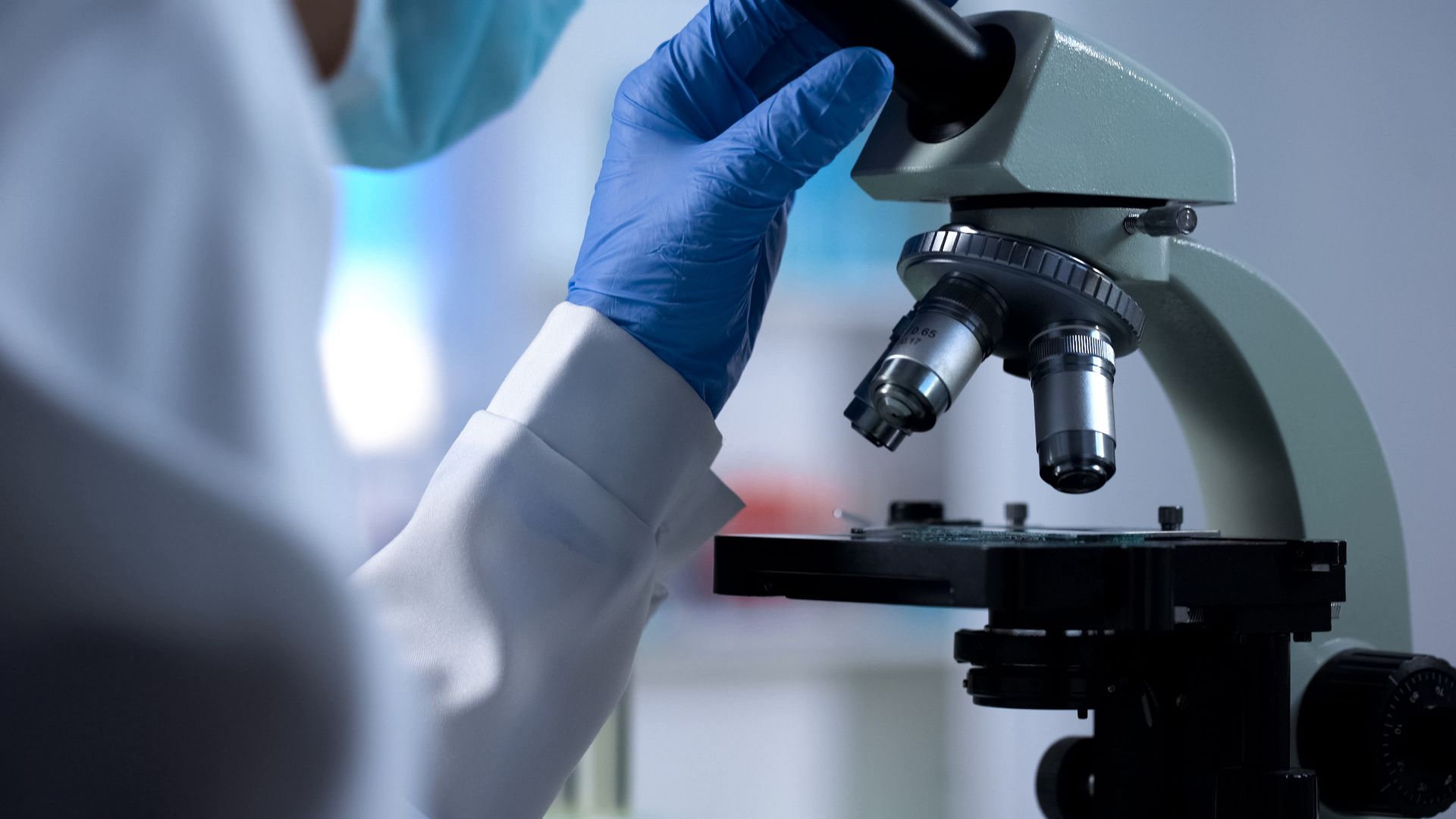 closeup of doctor using microscope