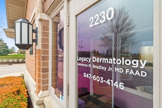 Legacy Dermatology office entrance with glass door, brick wall, address 2230, and phone number 847-603-4146