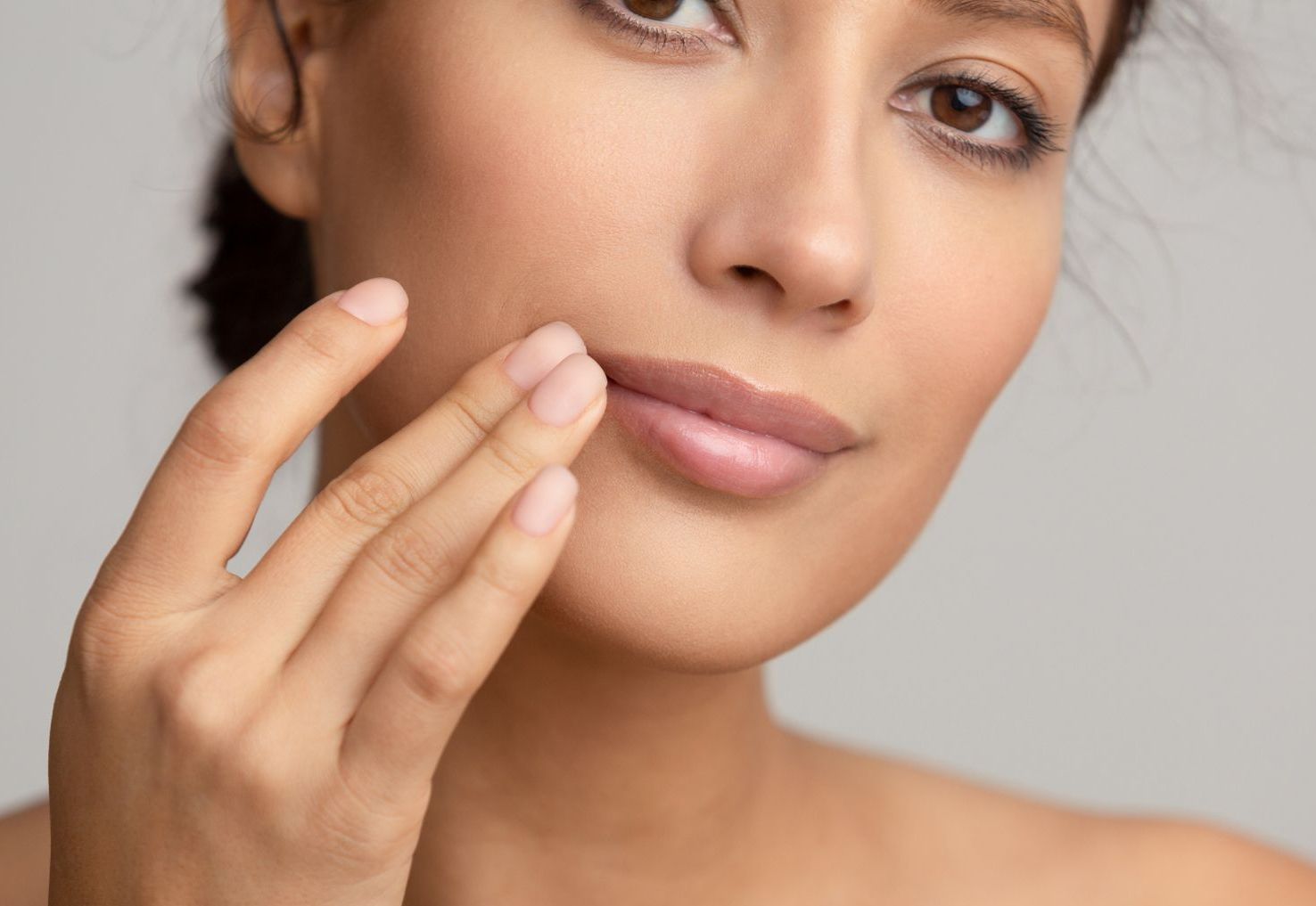 closeup of middle age woman touching lips