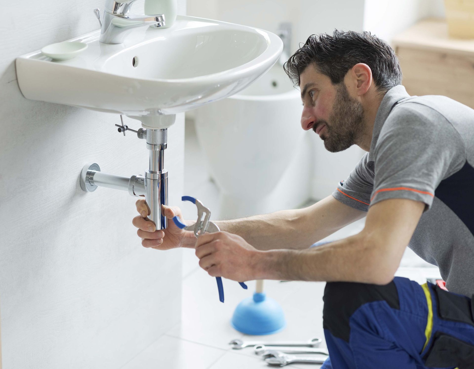Plumber fixing a sink.
