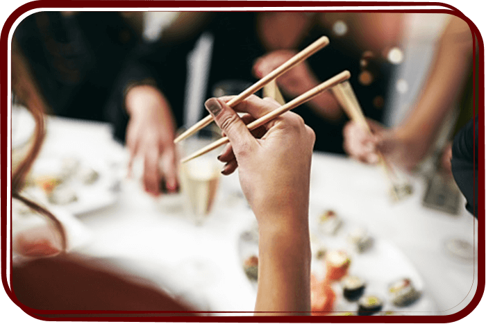 woman holding chopsticks at dinner