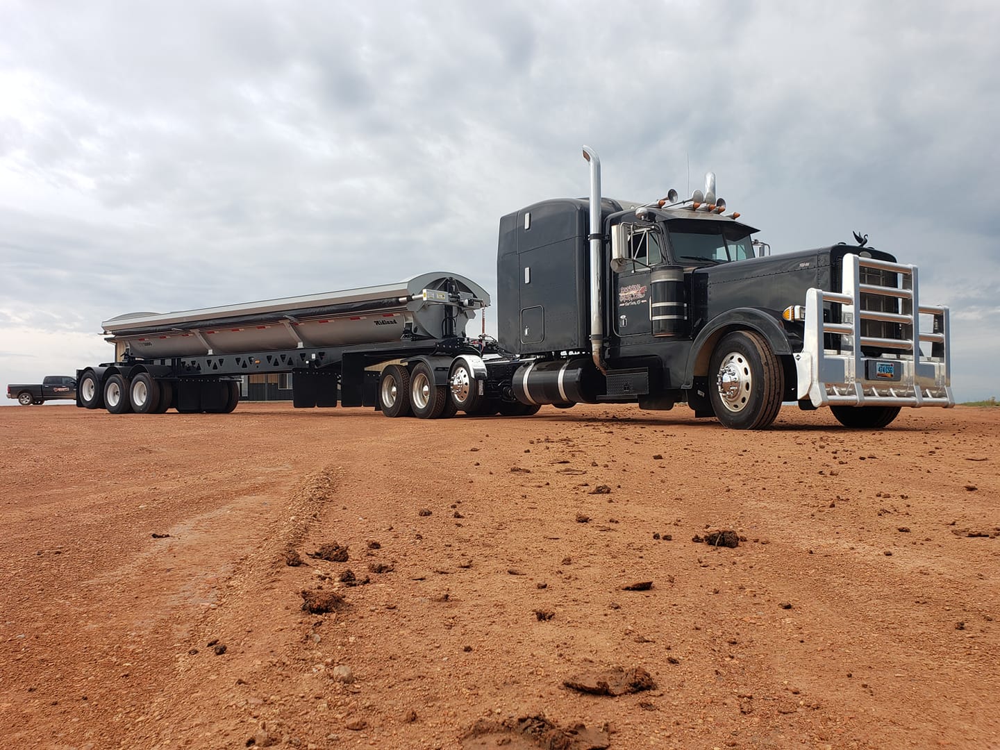 Side view of a black loaded truck