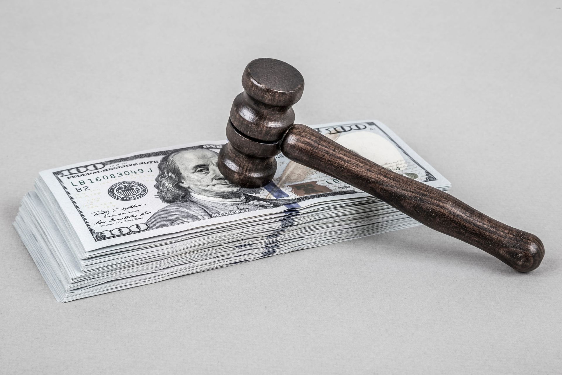Judge’s gavel resting on a stack of US dollar bills