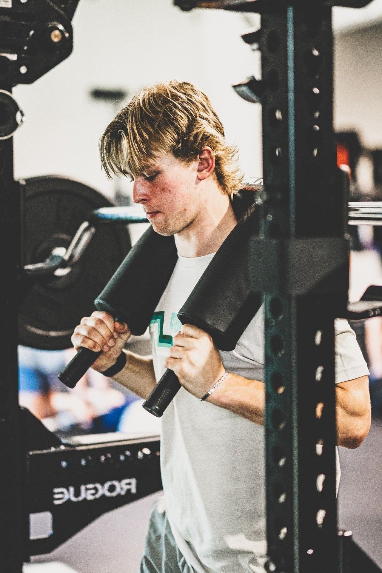 Focused goalie athlete performing lower-body strength work inside the Ghost Athletica facility Focused goalie athlete performing lower-body strength work inside the Ghost Athletica facility
