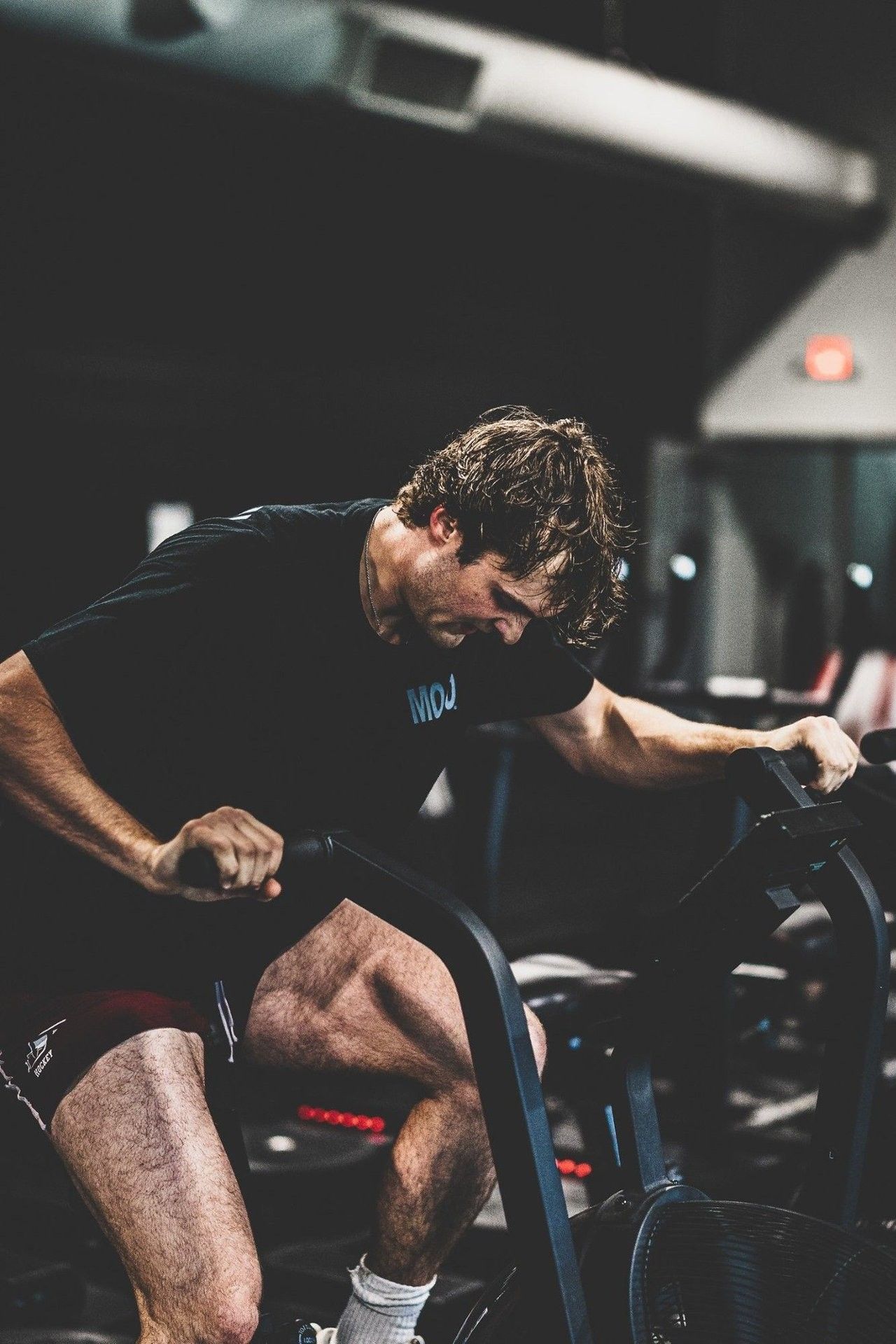 Hockey athlete on an air bike during off-ice hockey fitness testing at Ghost Athletica