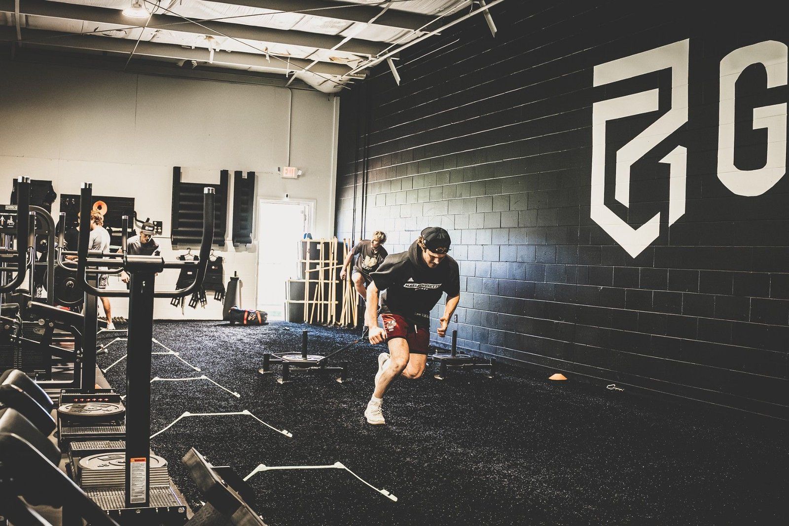 Hockey athlete performing an explosive sled pull inside the Ghost Athletica training facility Hockey athlete performing an explosive sled pull inside the Ghost Athletica training facility