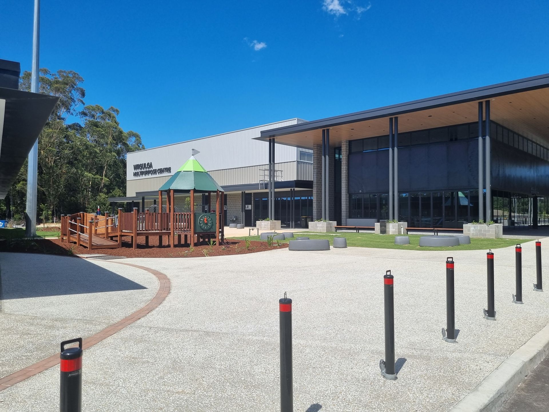 A Playground With a Brown Wooden Structure in Front of a Building — Acheson Building Certification in Nambucca Heads, NSW