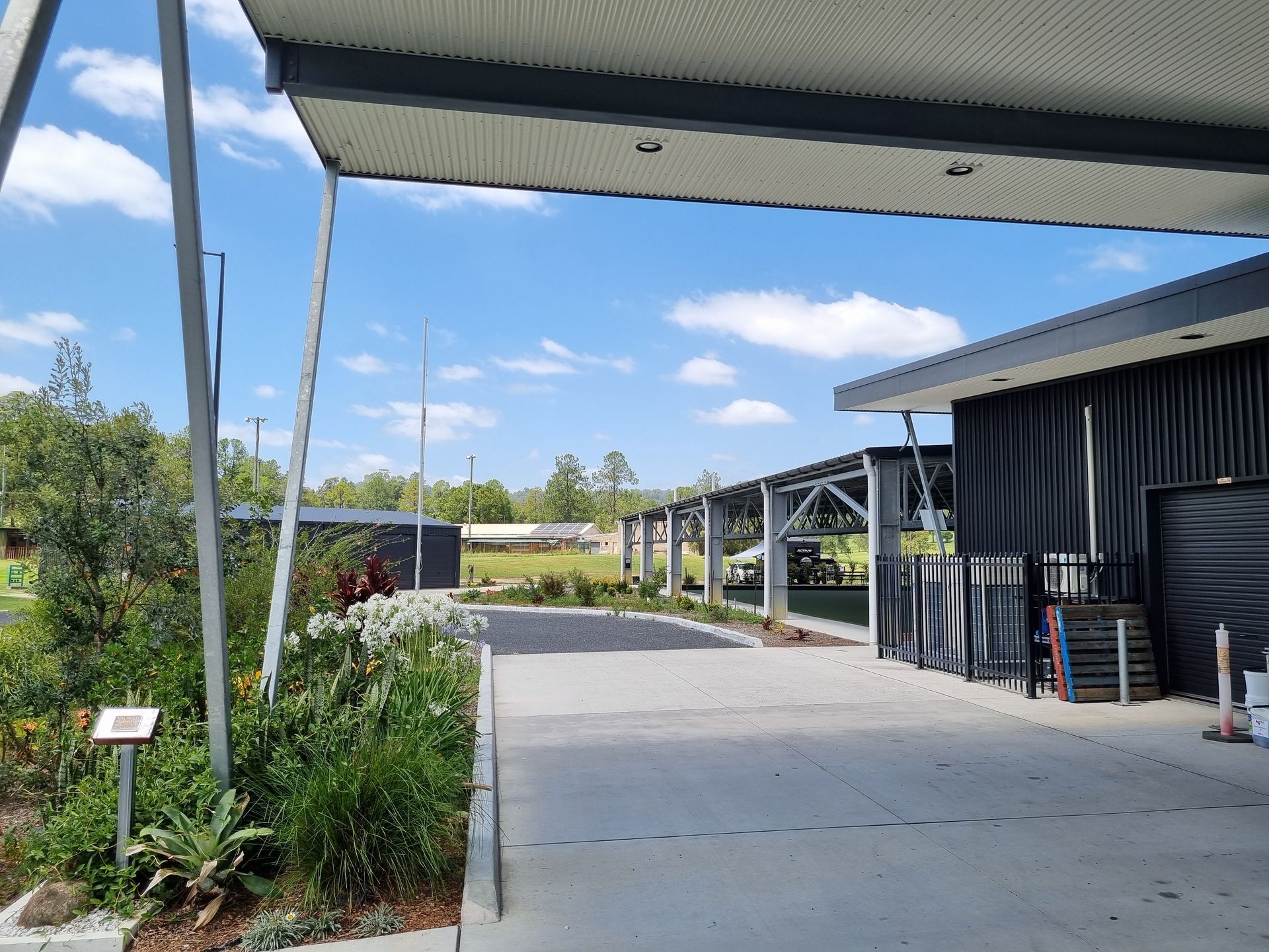 Concrete Driveway Under a Shaded Structure, Leading to a Building — Acheson Building Certification in Nambucca Heads, NSW