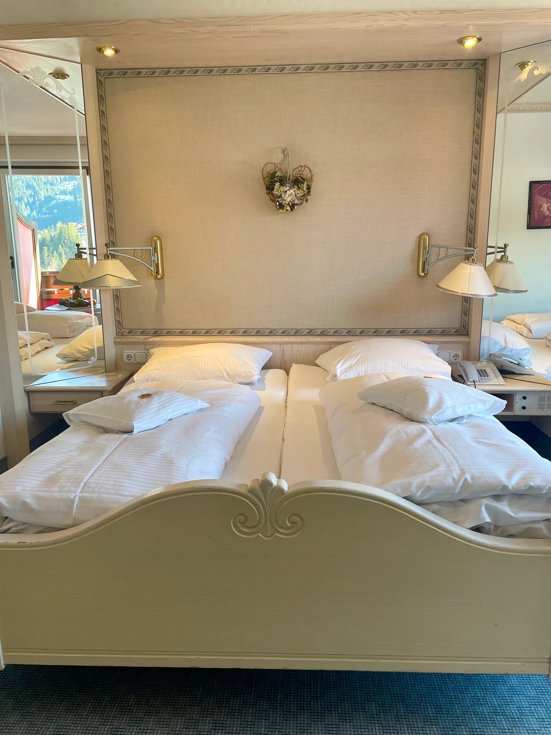 Ein Bett mit weißen Laken und Kissen in einem Hotelzimmer
