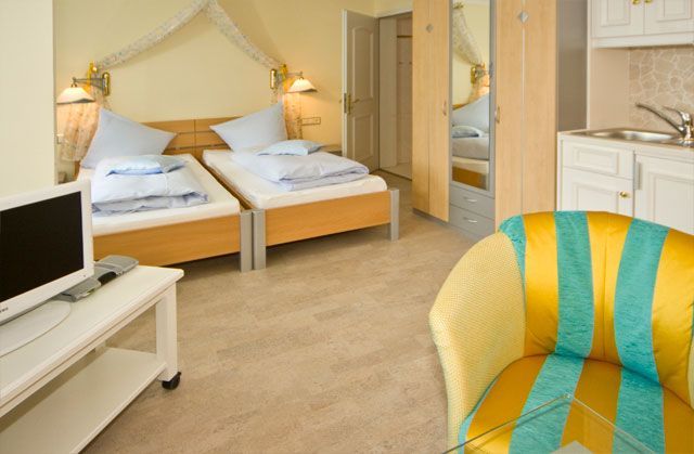 Ein Hotelzimmer mit zwei Betten und einem Stuhl