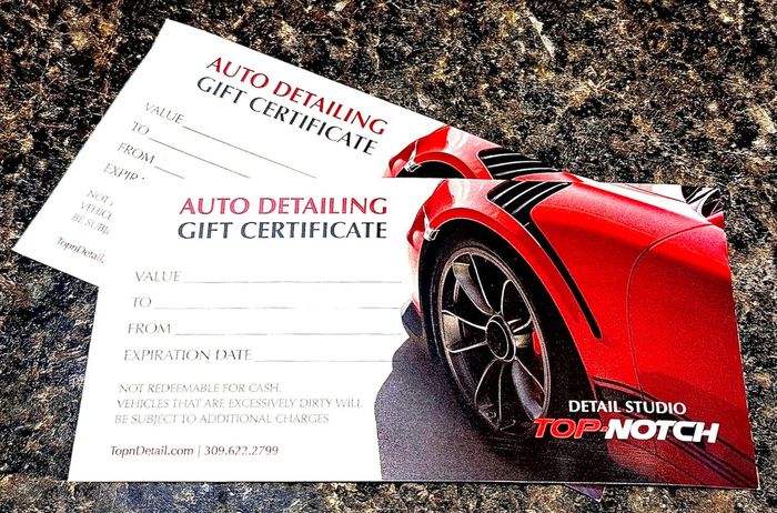 Two auto detailing gift certificates, one showing a red sports car.