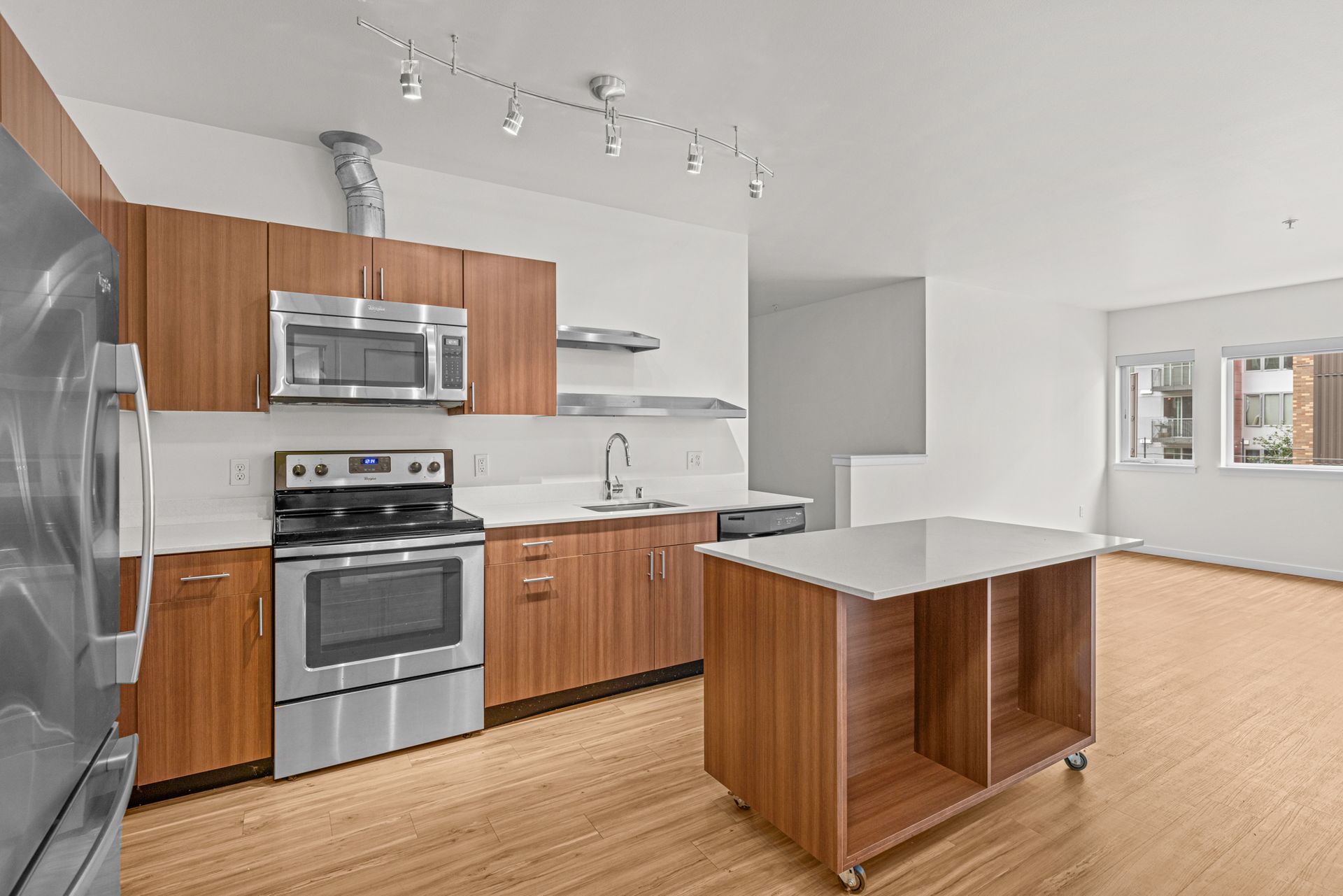 A kitchen with stainless steel appliances and wooden cabinets