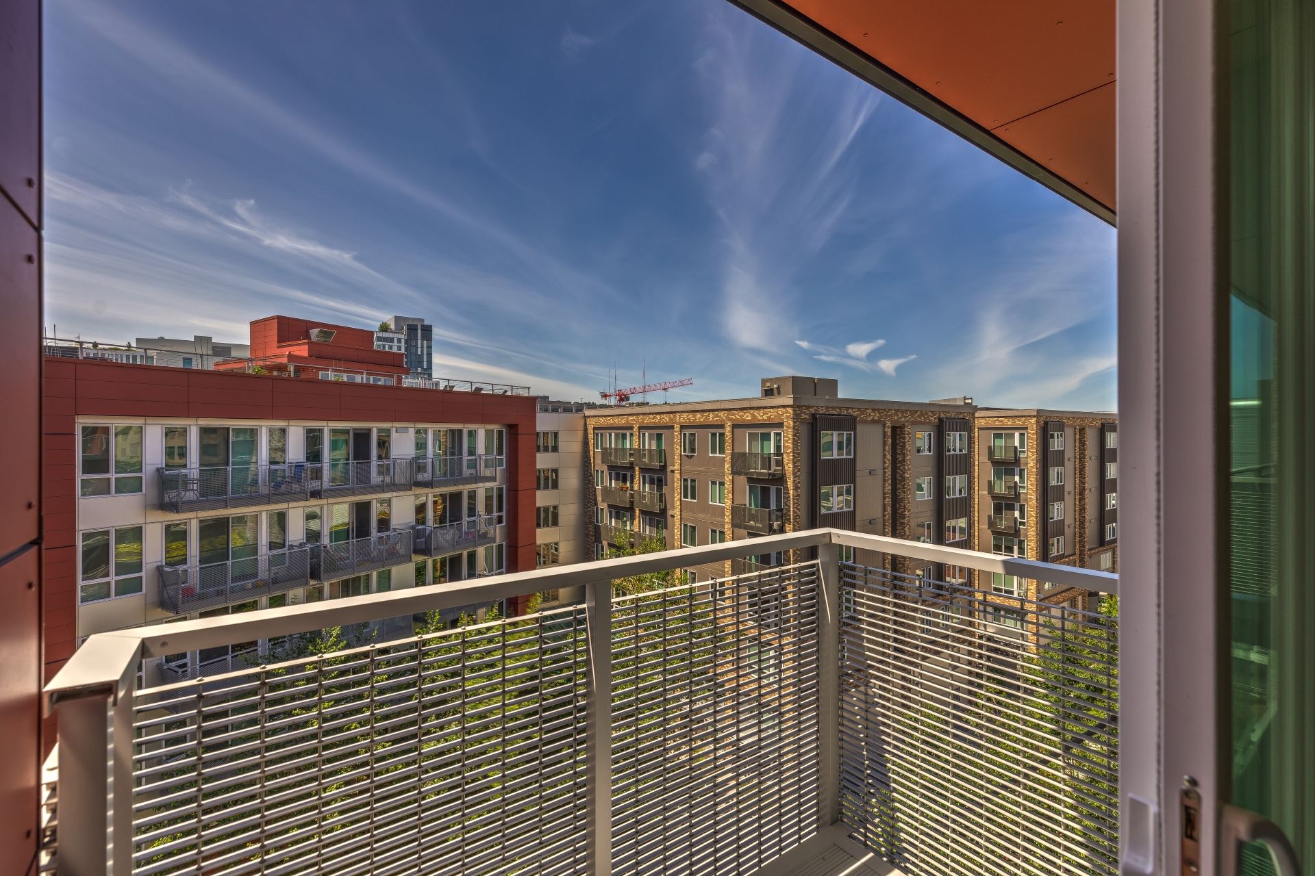 A balcony with a view of a city and buildings at Stack House.