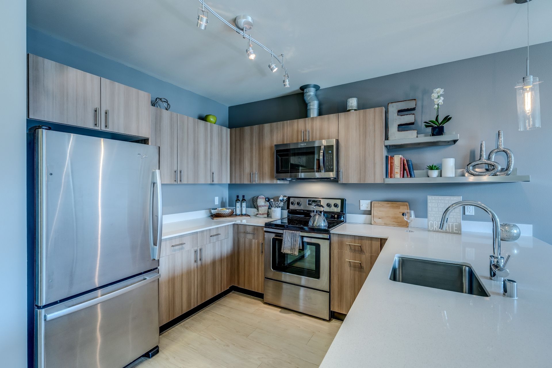 A kitchen with stainless steel appliances and wooden cabinets at Stack House.