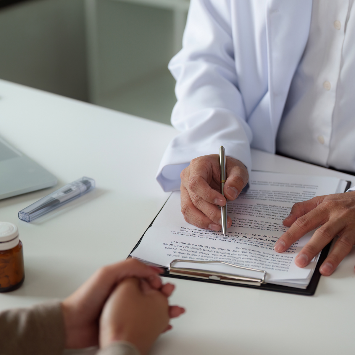 Doctor and patient writing during a medical consultation