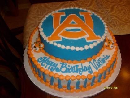 Orange and blue birthday cake with an Auburn “AU” logo and “Happy Birthday” icing message