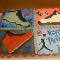 Four decorated cake squares with colorful icing and a “Happy Birth…” message