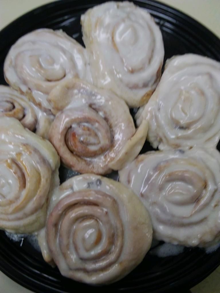 Plate of spiral glazed pastries on a dark dish