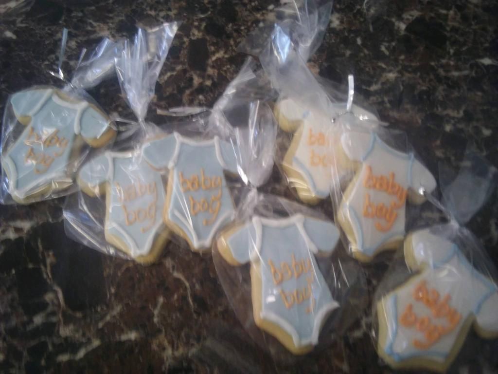 Assorted wrapped cookies on a dark marble countertop in clear plastic bags