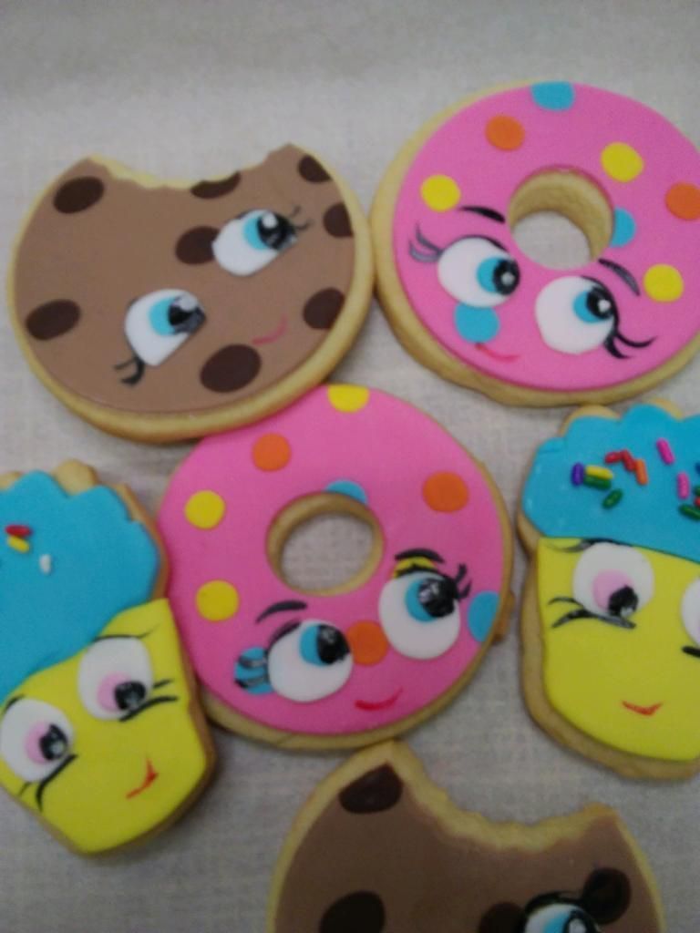 Colorful cartoon donut-shaped trinkets with eyes and smiles on a light background