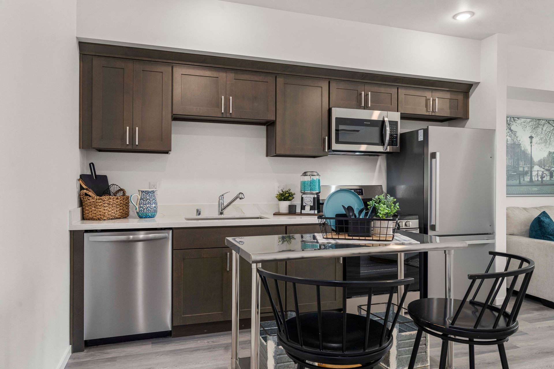 Modern kitchen with stainless steel appliances and dark wood cabinets at Blueberry Apartments Port Orchard