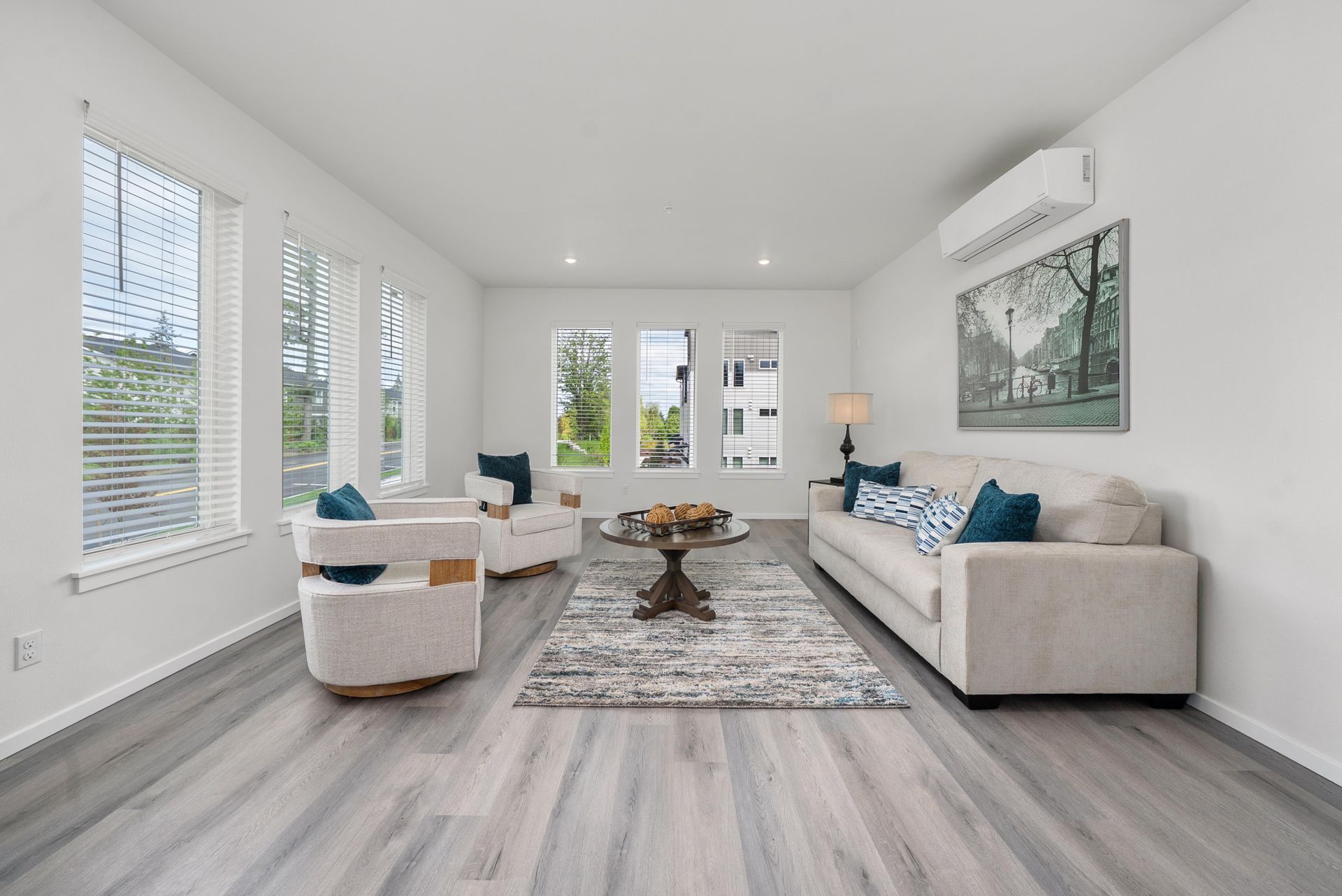 Bright living room with vinyl plank flooring at Blueberry Apartments Port Orchard.