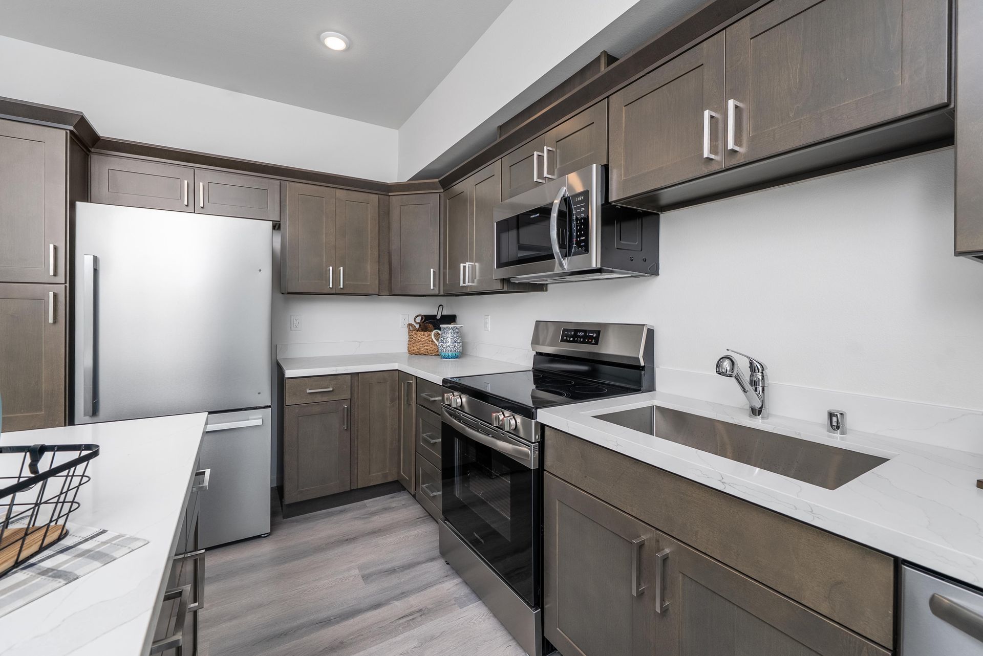 Kitchen area with dark cabinets and stainless steel refrigerator at Blueberry Apartments Port Orchard rentals