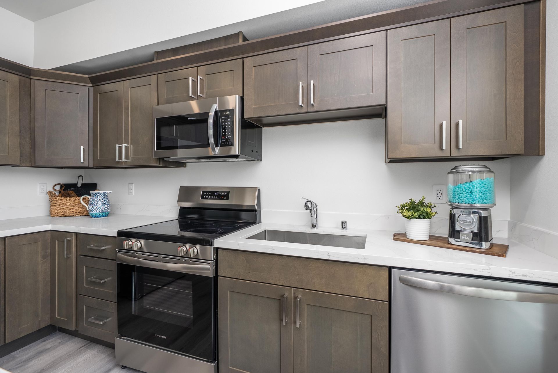 Kitchen with dark cabinets and stainless steel appliances at Blueberry Apartments Port Orchard