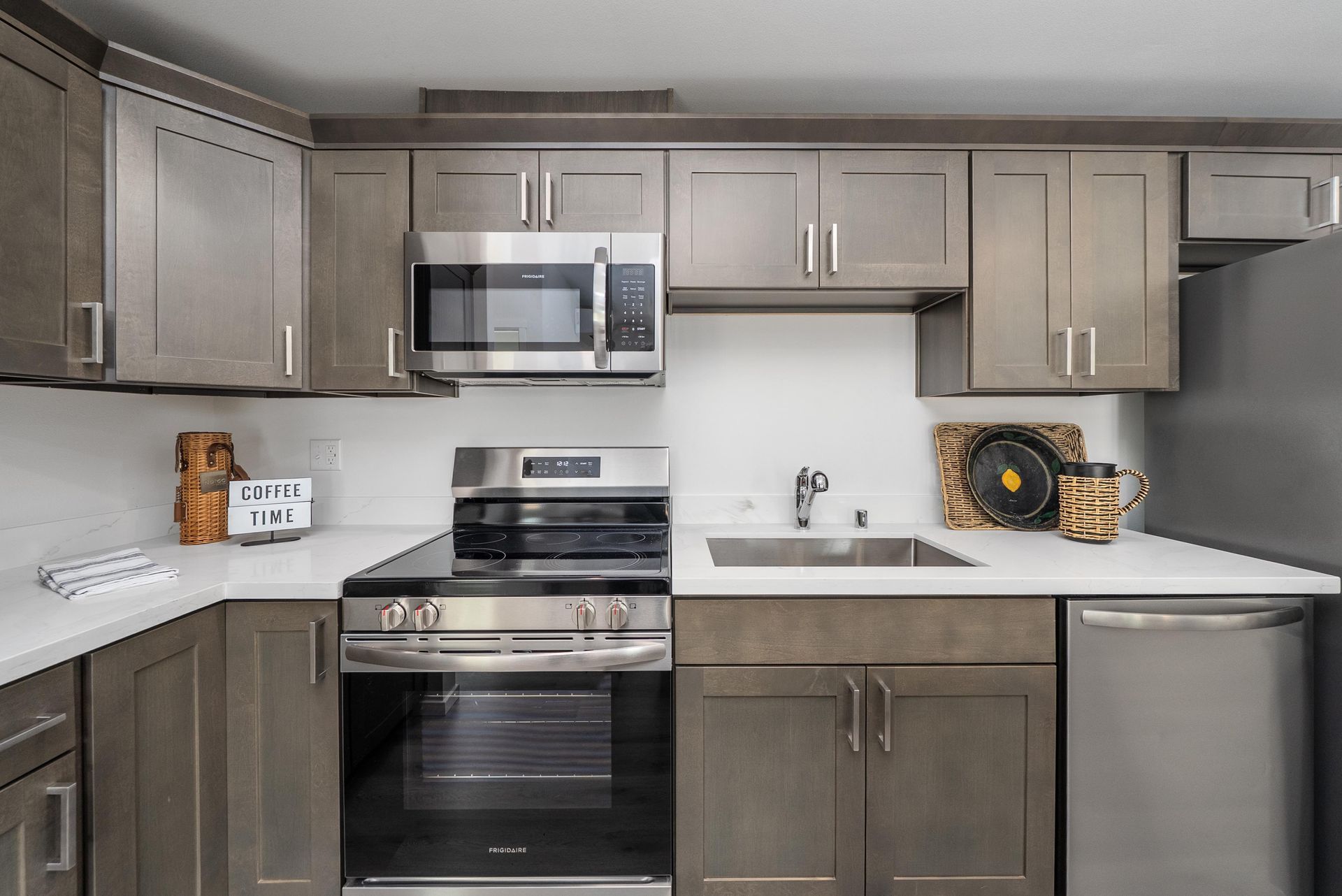 Kitchen sink area with stainless steel faucet and microwave at Blueberry Apartments Port Orchard