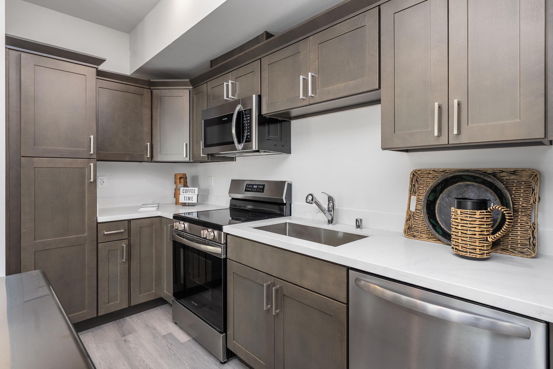 Kitchen with grey cabinets and stainless steel appliances at Blueberry Apartments Port Orchard