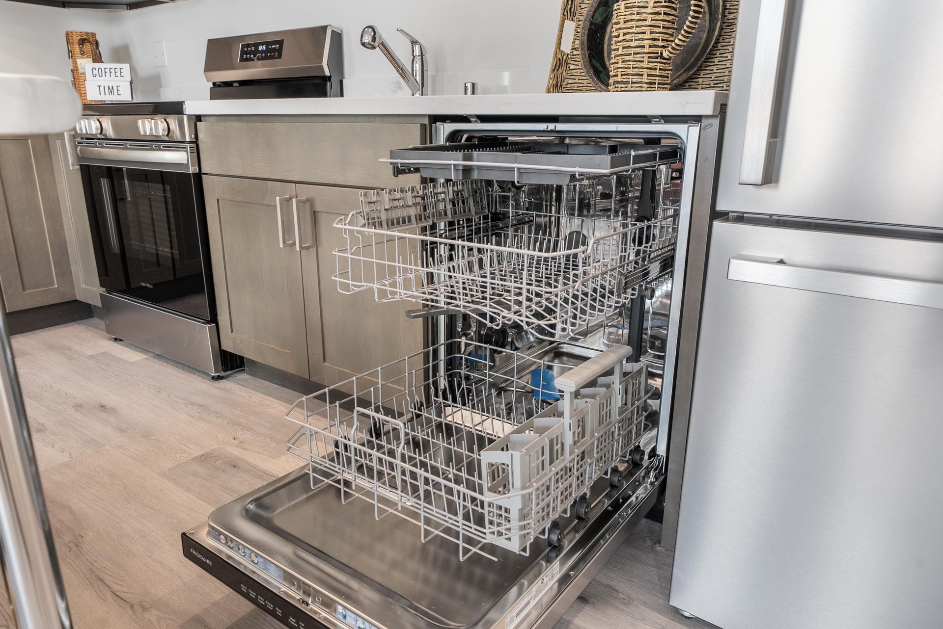 Stainless steel dishwasher open in a kitchen at Blueberry Apartments rentals, Port Orchard