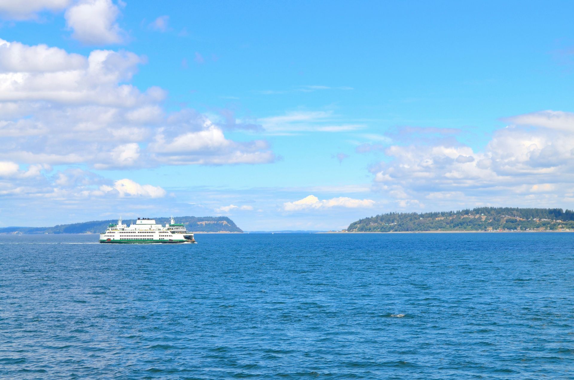 A boat is floating on top of a large body of water.