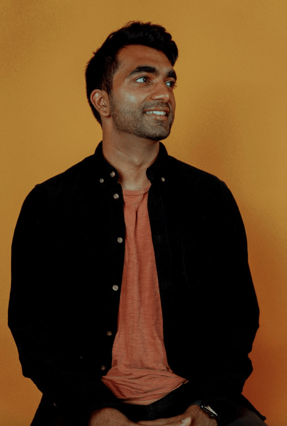 A photo of Ameet Kallaracki, gazing off to the right and smiling slightly.