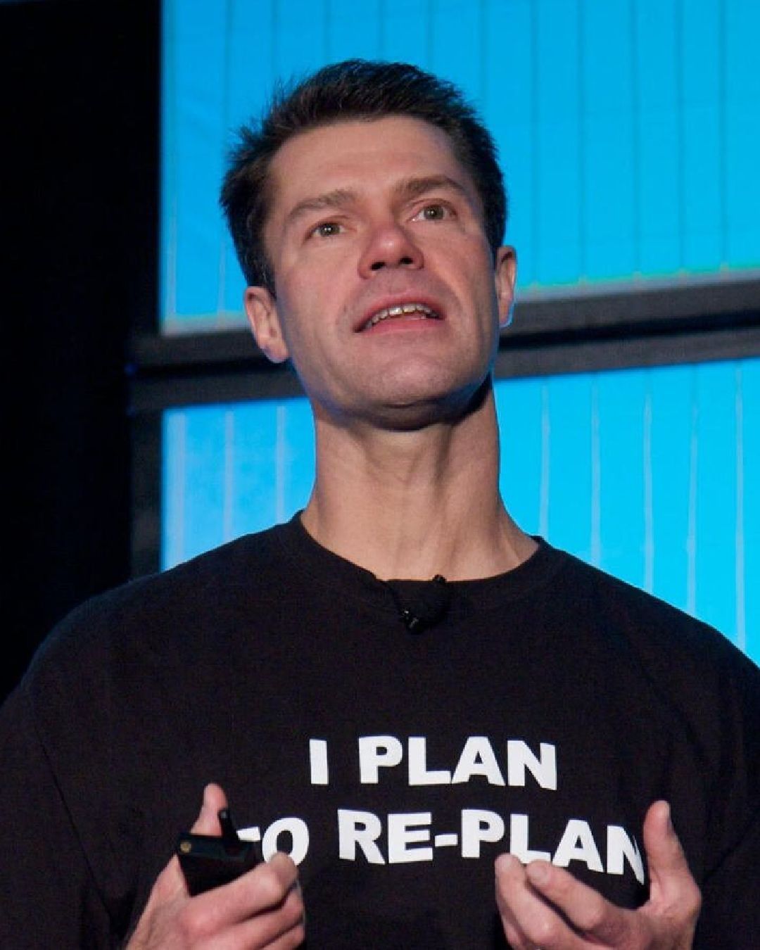 A close up photo of Luke Holmann while he speaks on a stage. 